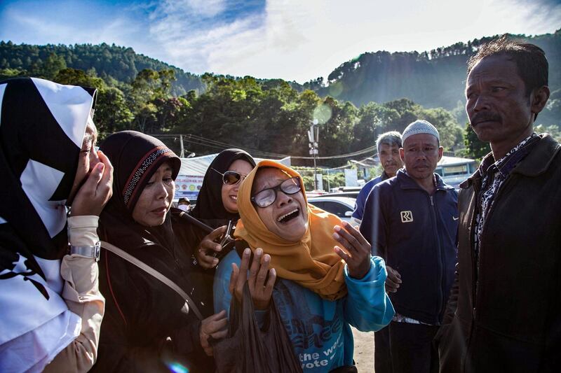 Family members of missing victims of a capsized ferry mourn during a mass memorial service at Lake Toba in North Sumatra. The retrieval of scores of bodies from an Indonesian ferry that sunk into the depths of one of the world's deepest lakes is being called off, a rescue official said on July 2. Ivan Damanik / AFP