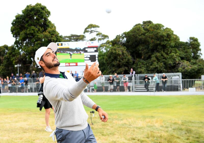 Abraham Ancer of Mexico throws balls to fans on the 18th green after he and Marc Leishman of Australia halved their match against Rickie Fowler and Justin Thomas. Getty