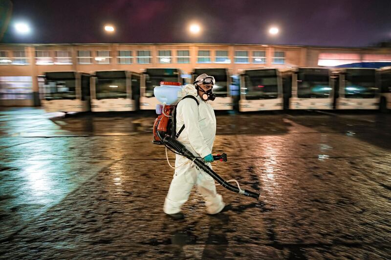 An employee of the pubic transport company during the daily disinfection of buses in the early morning hours in Bucharest, Romania. AP Photo
