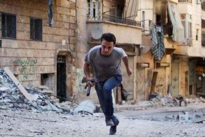 A Free Syrian Army fighter runs to take cover in Aleppo's Salaheddine neighbourhood.