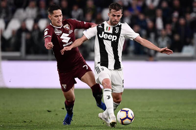 Torino midfielder Sasa Lukic, left, vies with Juventus midfielder Miralem Pjanic. AFP