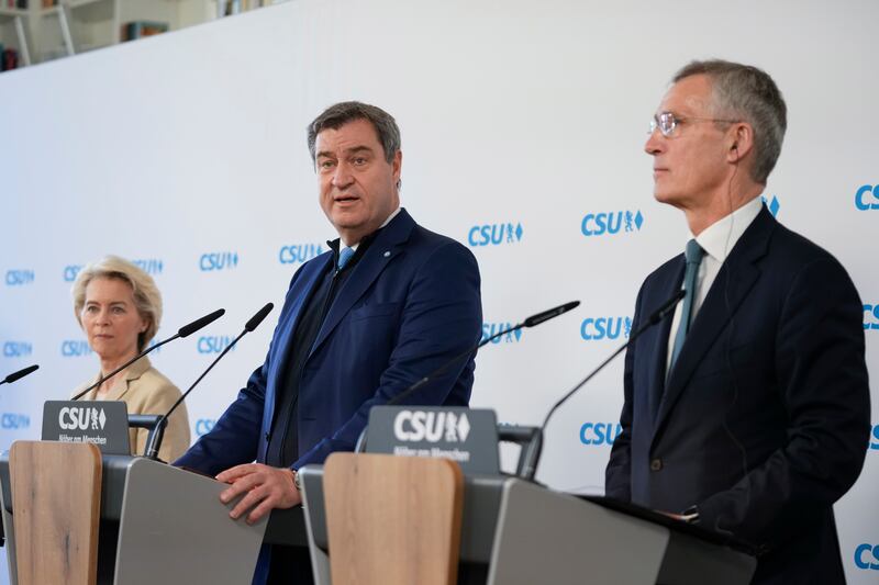 From left, European Commission President Ursula von der Leyen, Bavarian state premier Markus Soder and Nato Secretary General Jens Stoltenberg address the opening session. AP