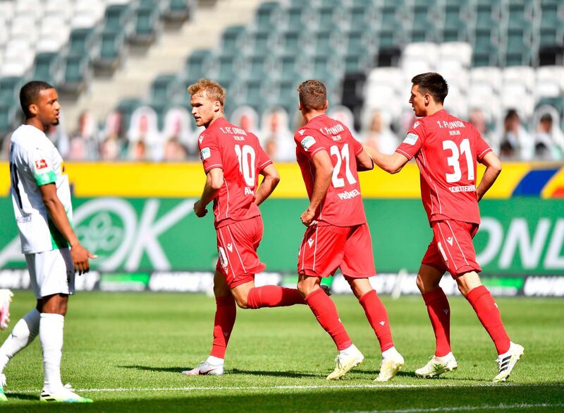 Union Berlin's Swedish forward Sebastian Andersson, second left, celebrates after scoring to reduce Borussia Monchengladbach. AFP