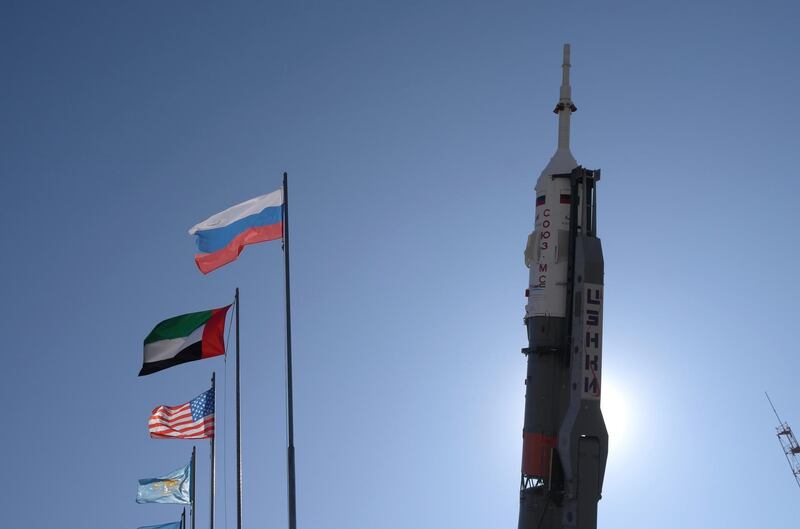 The Emirati, Russian and American flags fly as the Soyuz rocket stands in its vertical take-off position. James Langton / The National