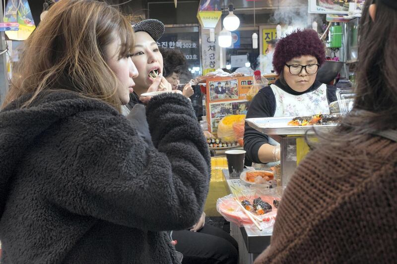 SEOUL, KOREA. 01 MARCH 2018. General image from Seoul in South Korea. Food for sale in the famous Gwangjang food market. Visitors to the market enjoy some food stall offerings. (Photo: Antonie Robertson/The National) Journalist: Caline Maalek. Section: National.