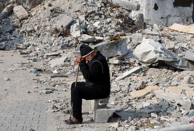 A Palestinian man sits near the rubble of a house destroyed in an Israeli strike in Rafah. Reuters