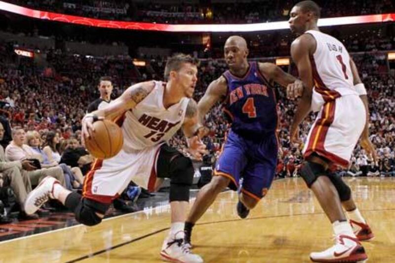 Miami Heat's Mike Miller (13) drives as teammate Chris Bosh, right, looks on and New York Knicks'  Chauncey Billups (8) defends in the third quarter of an NBA basketball game in Miami, Sunday, Feb. 27, 2011. (AP Photo/Alan Diaz)