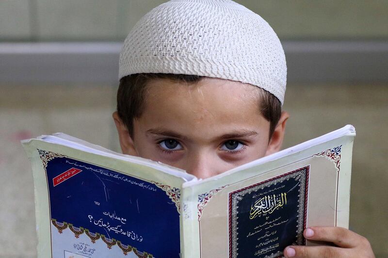 A Pakistani Muslim boy learns to read the holy Quran at a mosque in Karachi.  EPA