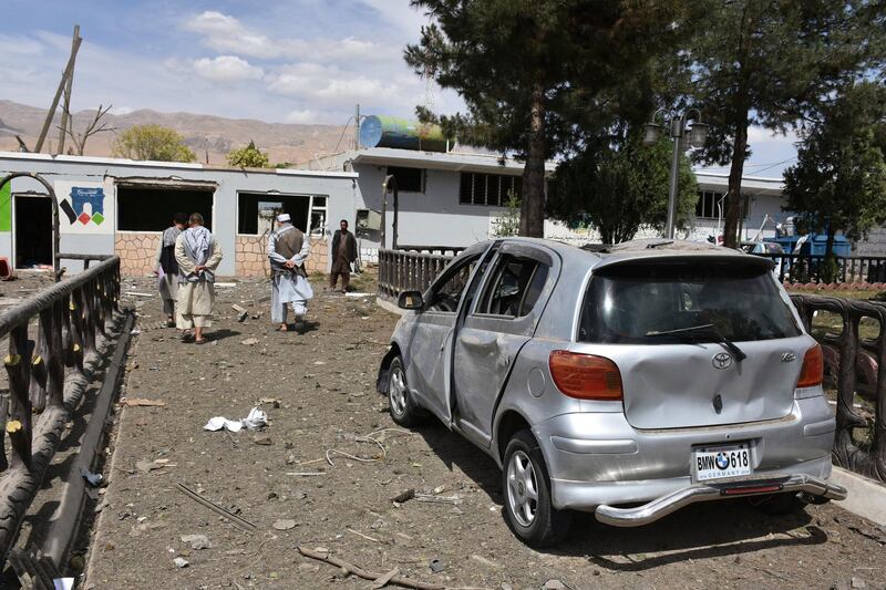 Afghan people inspect the site of a car bomb blast on an intelligence compound in Aybak, the capital of the Samangan province in northern Afghanistan. AP