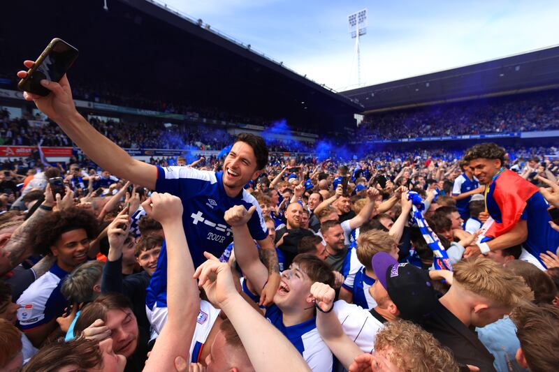Lewis Travis of Ipswich Town celebrates promotion to the Premier League with supporters. Getty Images