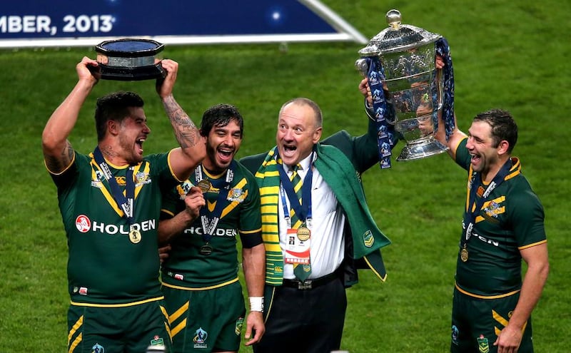 Andrew Fifita, Johnathan Thurston, Tim Sheens and Cameron Smith of Australia celebrate winning with the Rugby League World Cup. Alex Livesey / Getty Images