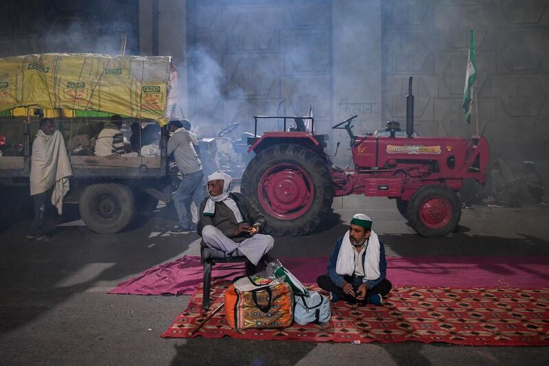 Farmers rest under a bridge near a police road block stopping them from marching to New Delhi to protest against the central government's recent agricultural reforms.  AFP