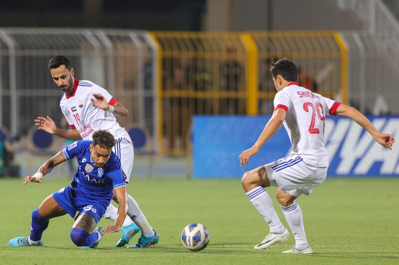 Hilal midfielder Matheus Pereira is marked by Sharjah defender Khaled Ibrahim and midfielder Otabek Shukurov.