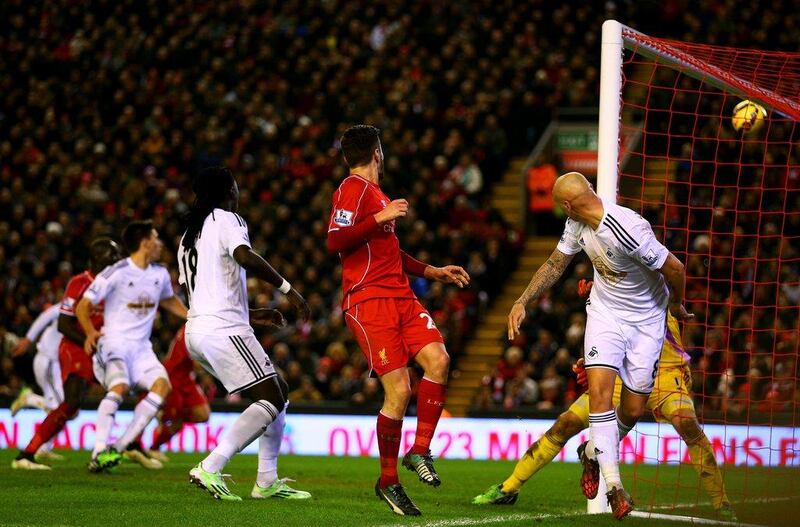 Jonjo Shelvey of Swansea City heads in an own goal during his side's Premier League loss on Monday to Liverpool. Clive Brunskill / Getty Images