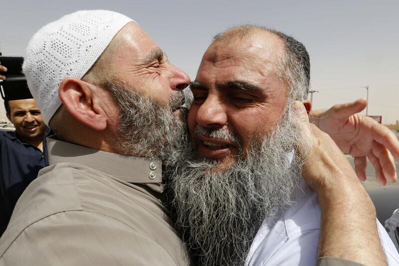 Radical Muslim cleric Abu Qatada, right, hugs his father after being released from prison after a Jordanian court acquitted him of providing spiritual and material support for a plot to attack tourists during Jordan's New Year celebrations in 2000. Muhammad Hamed/Reuters