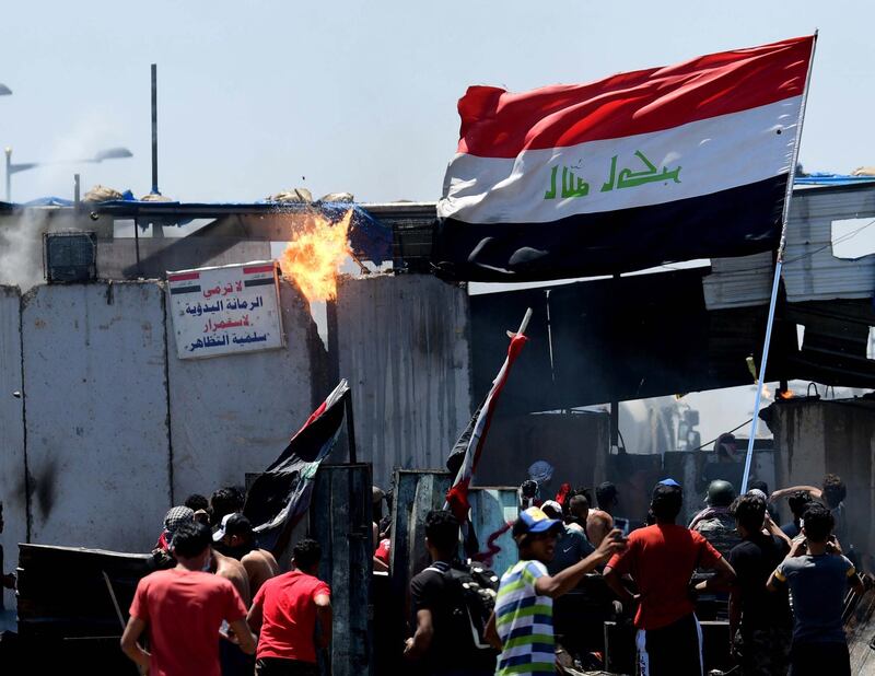 Protesters clash with anti-riot police on the Al-Jumhuriya bridge, which leads to the headquarters of the Iraqi government inside the high security Green Zone area, during an anti-government protest in Baghdad, Iraq.  EPA