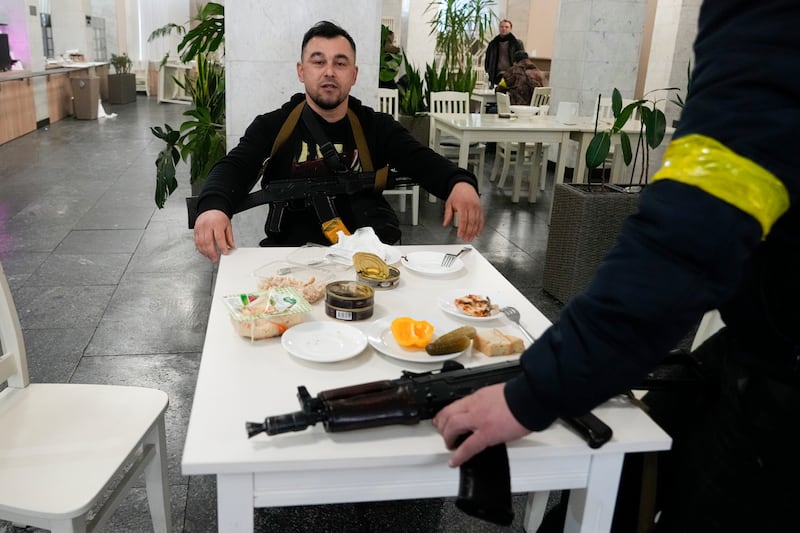 Civil defence members eat during a break at City Hall in Kiev. AP
