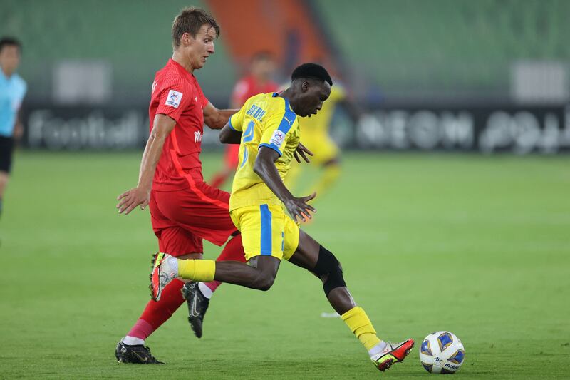 Shabab Al Ahli forward Thomas Lehne Olsen vies for the ball with Gharafa defender Saeed el-Hadj. AFP