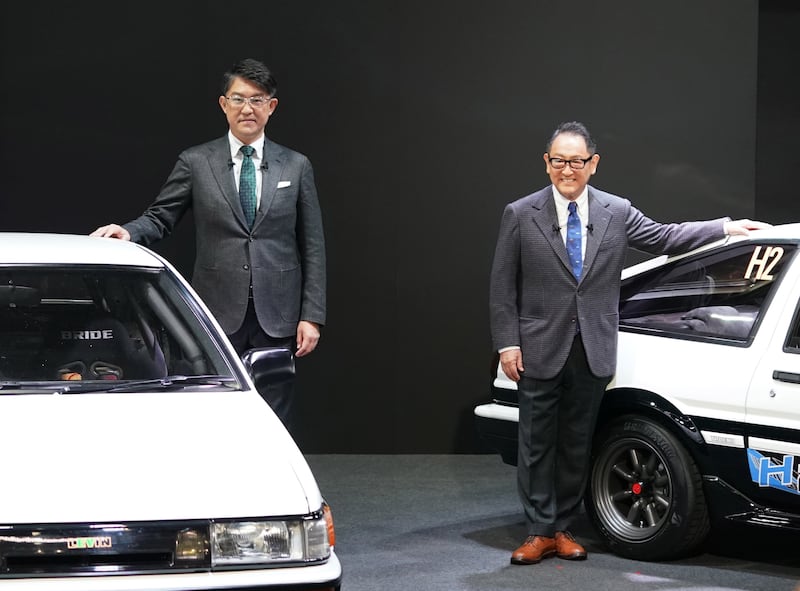 Toyota Motor chief executive Koji Sato, left, and chairman Akio Toyoda. Mr Sato says he intends to take a bolder and faster 'EV first' approach. EPA