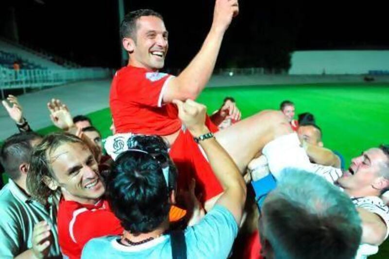 Croatian soccer player Mario Cizmek is carried by his teammates and fans after victory in a national cup match in Zagreb.