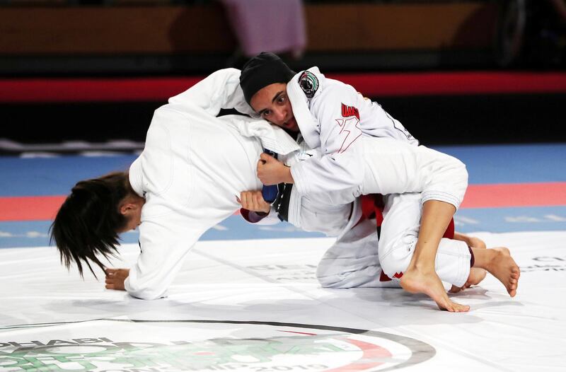 ABU DHABI,  UNITED ARAB EMIRATES , April 21 – 2019 :- Hamda Alshkeili ( red from UAE Al Wahda Club Jiu Jitsu Academy ) vs Kinaree Adkins ( blue from Fama ) during the 48kg category in the Abu Dhabi World Professional Jiu Jitsu  Championship 2019 held at the Mubadala Arena in Abu Dhabi. Hamda red won the fight. ( Pawan Singh / The National ) For Sports. Story by Amith