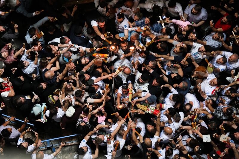 Christian worshippers gather at the Tomb of Christ as they wait for the 'Holy Fire' ceremony to occur, in the Church of the Holy Sepulchre, in Jerusalem. EPA 