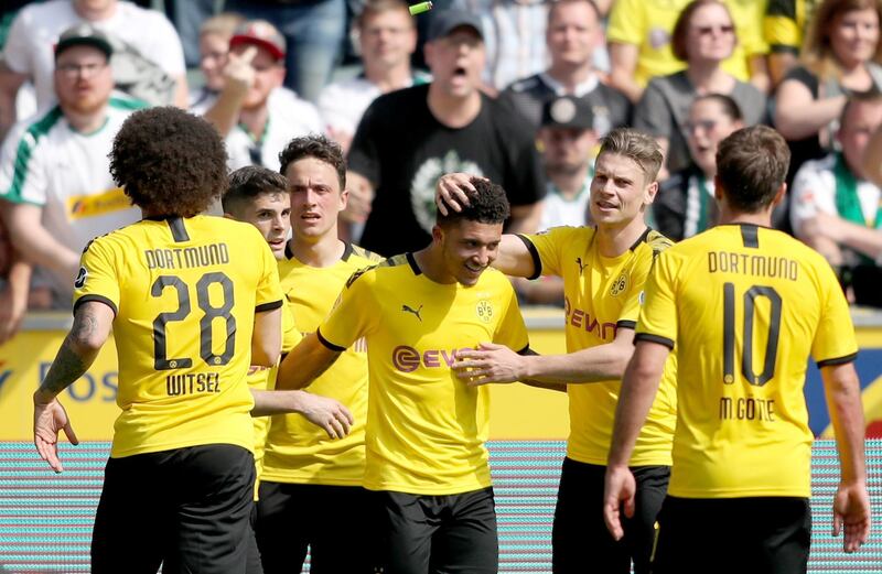 epa07581035 Dortmunds players celebate with Dortmund's Jadon Sancho (C) Sancos's 0-1 goal during the German Bundesliga soccer match between Borussia Moenchengladbach and Borussia Dortmund at Borussia-Park in Moenchengladbach, Germany, 18 May 2019.  EPA/FRIEDEMANN VOGEL CONDITIONS - ATTENTION: The DFL regulations prohibit any use of photographs as image sequences and/or quasi-video.
