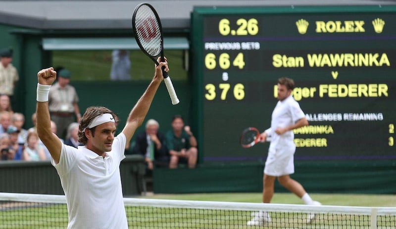 Roger Federer celebrates beating Stan Wawrinka on Wednesday to reach the 2014 Wimbledon Championships semi-finals. Andrew Cowie / AFP