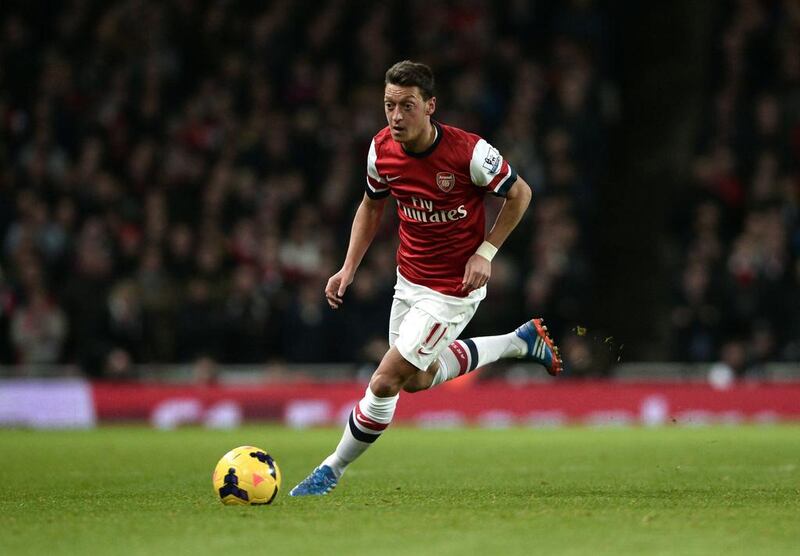 Arsenal's Mesut Ozil runs with the ball during an English Premier League match against Liverpool at the Emirates stadium. Dylan Martinez / Reuters
