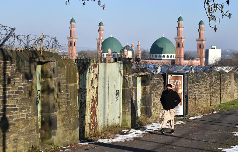 BRADFORD, ENGLAND - FEBRUARY 12: A man walks past Al-Jamia Suffa-Tul-Islam Grand Mosque on February 12, 2021 in Bradford, England. (Photo by Nathan Stirk/Getty Images)