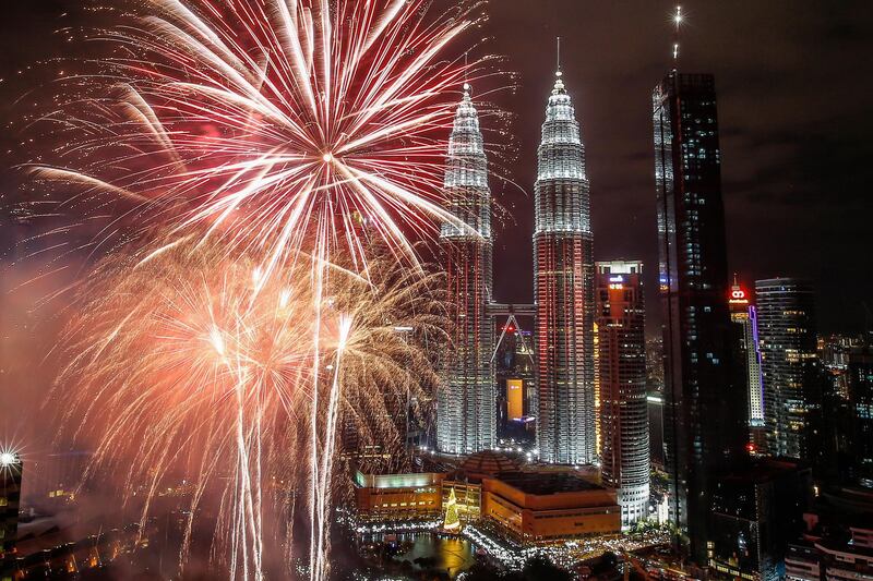Fireworks illuminate the night sky over Malaysia's Petronas Towers during New Year's Eve celebrations in Kuala Lumpur. Ahmad Yusni / EPA