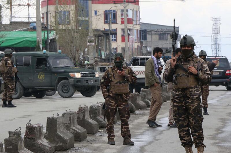 Afghan security personnel stand guard near the site of an attack to a Sikh temple in Kabul.  AFP