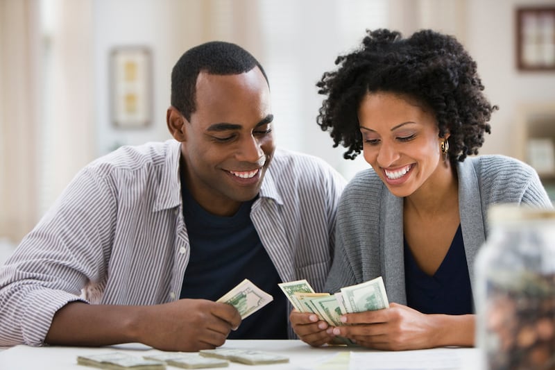 Getting on the same page as your partner when it comes to finances usually requires a lot of communication and sometimes a little compromise. Getty Images