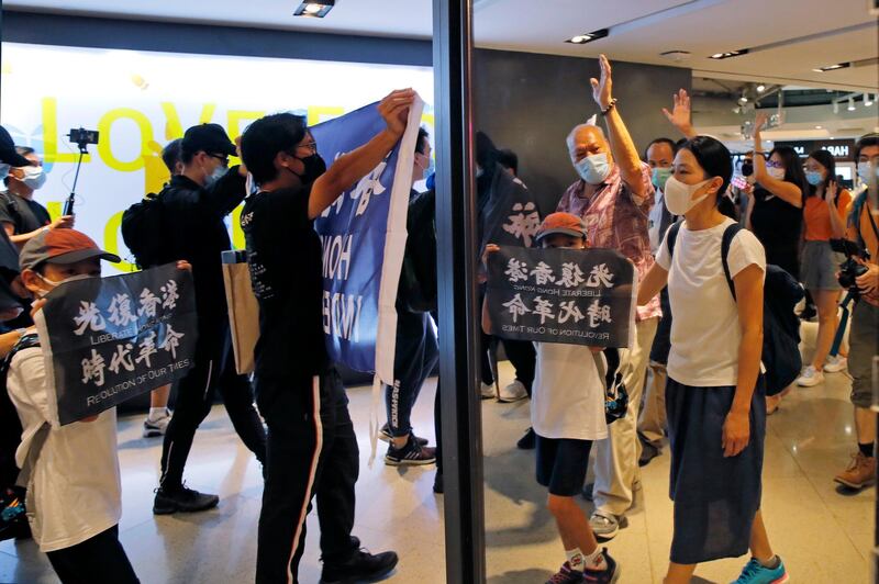 Protesters are reflected on a mirror as they march in a shopping mall during a protest in Hong Kong. Protesters in Hong Kong got its government to withdraw extradition legislation last year, but now they're getting a more dreaded national security law. And the message from Beijing is that protest is futile. AP Photo