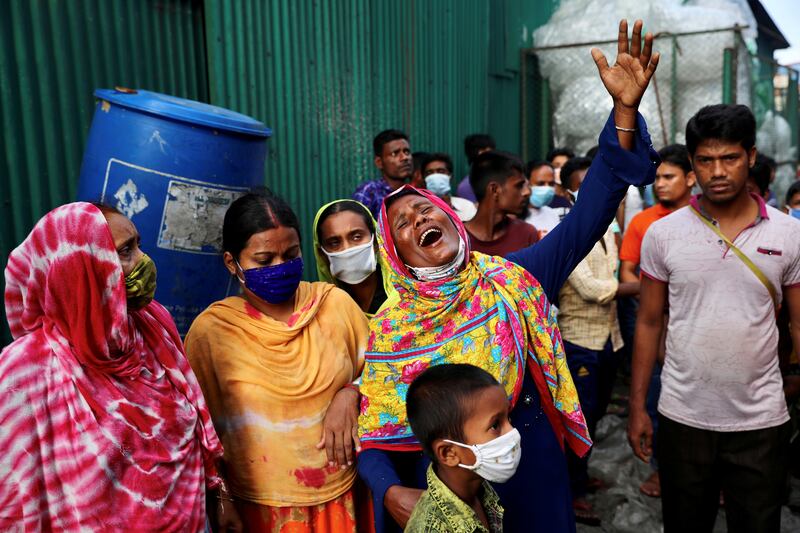 Unidentified relatives of the victims mourn at the site after a fire broke out at a factory named Hashem Foods Ltd., in Rupganj of Narayanganj district, on the outskirts of Dhaka, Bangladesh.