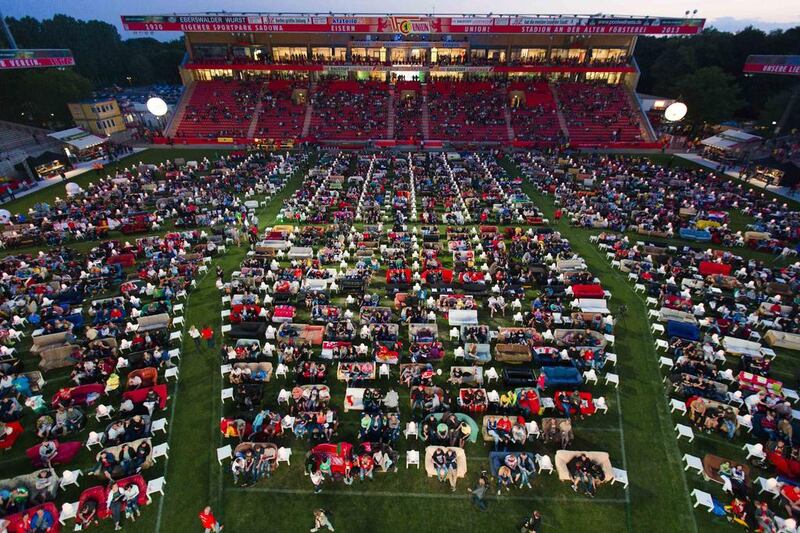 People sit on sofas as they watch the opening game of the 2014 World Cup between Brazil and Croatia, during a public viewing event at the Alte Forsterei stadium in Berlin on June 12, 2014. Thomas Peter / Reuters