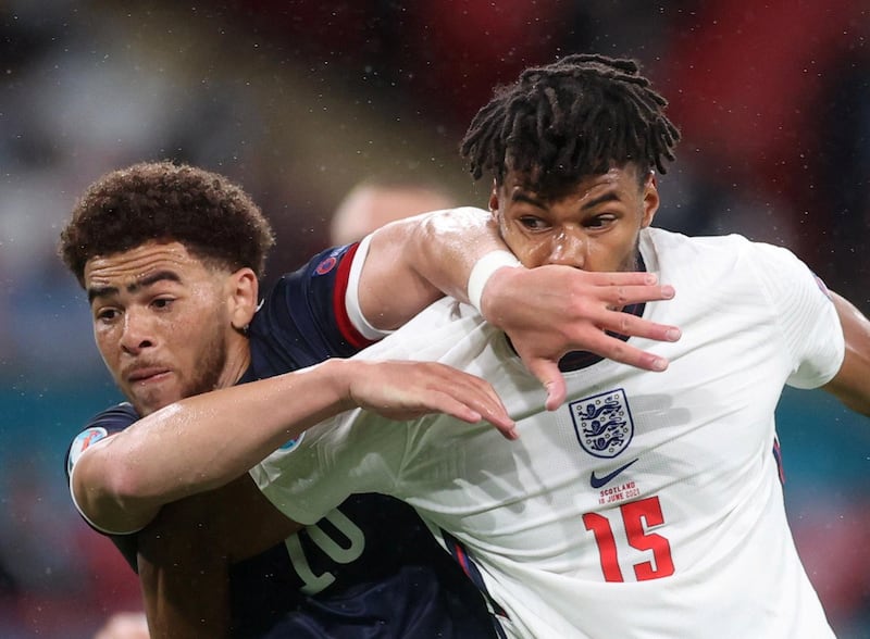 England's Tyrone Mings in action with Che Adams of Scotland. Reuters