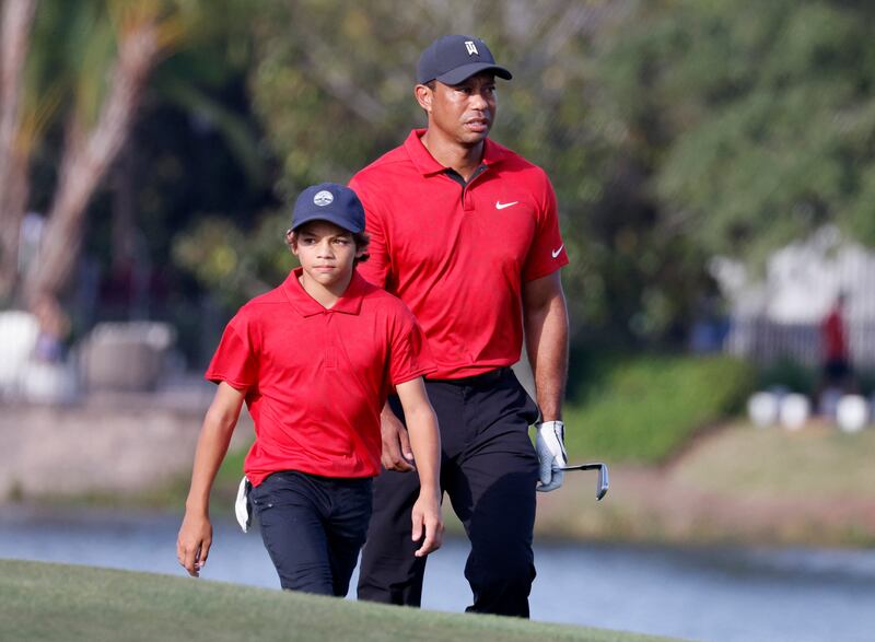 Tiger and son Charlie on the 18th hole. Reuters