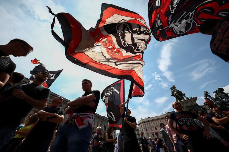 People wave flags in Milan. Reuters