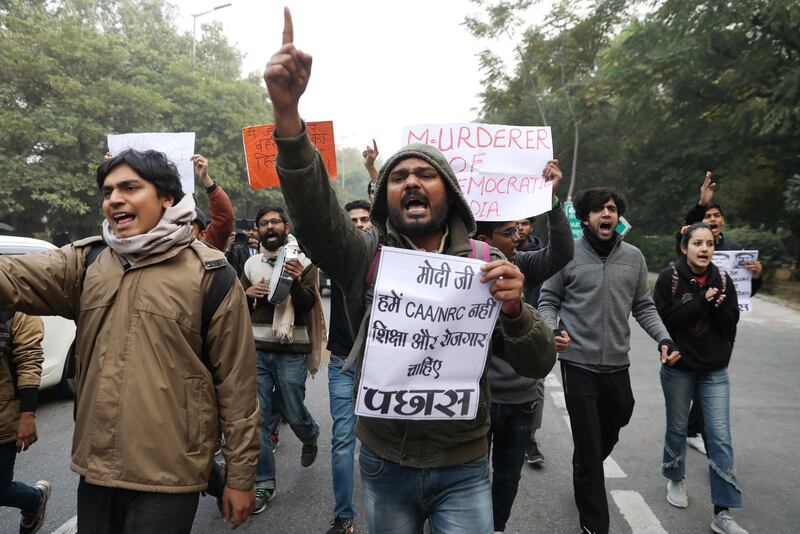 epa08091716 Indian student activists shout slogans during a protest against the alleged Police brutality on protesters in Uttar Pradesh state and against the Citizenship Amendment Act (CAA) and National Register of Citizens (NRC), outside Uttar Pradesh Bhawan in New Delhi, India, 27 December 2019. The bill will give Indian citizenship rights to refugees from Hindu, Jain, Buddhist, Sikhs, Parsi or Christian communities coming from Afghanistan, Bangladesh and Pakistan.  EPA/RAJAT GUPTA