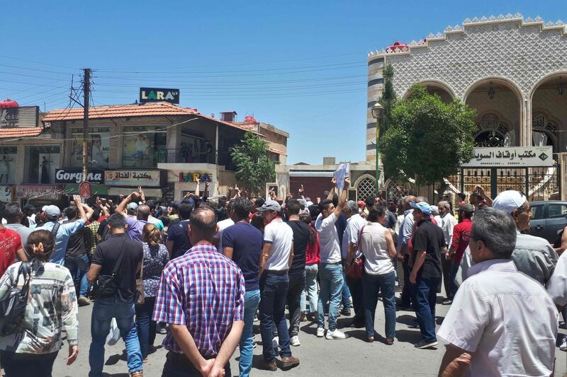 A handout picture released by the local news site Suwayda 24 shows Syrians chanting anti-government slogans as they protest the country's deteriorating economic conditions and corruption, in the southern city of Suwaida on June 9, 2020. == RESTRICTED TO EDITORIAL USE - MANDATORY CREDIT "AFP PHOTO / HO / SUWAIDA24" - NO MARKETING NO ADVERTISING CAMPAIGNS - DISTRIBUTED AS A SERVICE TO CLIENTS ==
 / AFP / SUWAYDA24 / - / == RESTRICTED TO EDITORIAL USE - MANDATORY CREDIT "AFP PHOTO / HO / SUWAIDA24" - NO MARKETING NO ADVERTISING CAMPAIGNS - DISTRIBUTED AS A SERVICE TO CLIENTS ==
