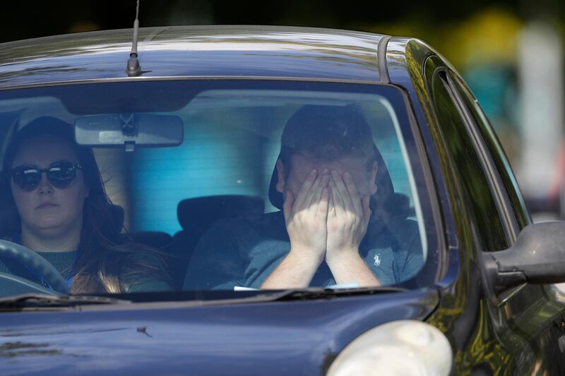 A worker reacts as he is driven from the Thomas Cook Headquarters in Peterborough, United Kingdom.  Getty Images
