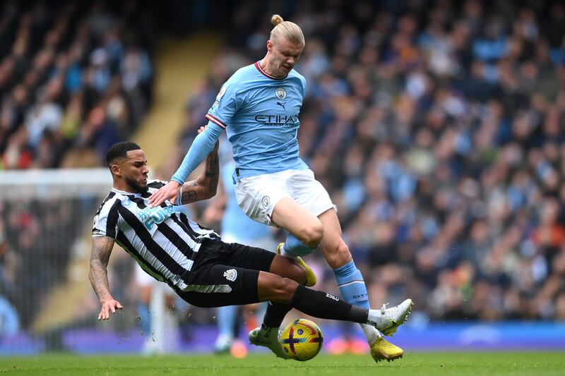 City striker Erling Haaland is tackled by Jamaal Lascelles of Newcastle. Getty