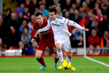 Liverpool's Andrew Robertson (left) and Leeds United's Brenden Aaronson battle for the ball during the English Premier League soccer match between Liverpool and Leeds United at Anfield in Liverpool, England, on Saturday, Oct.  29, 2022.  (Richard Sellers / PA via AP)