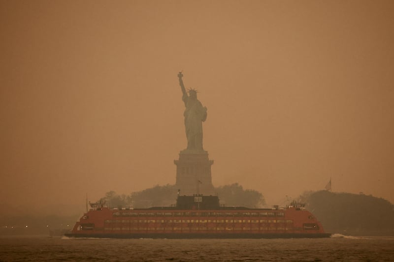 New York's Statue of Liberty is covered in haze and smoke caused by wildfires in Canada. Reuters