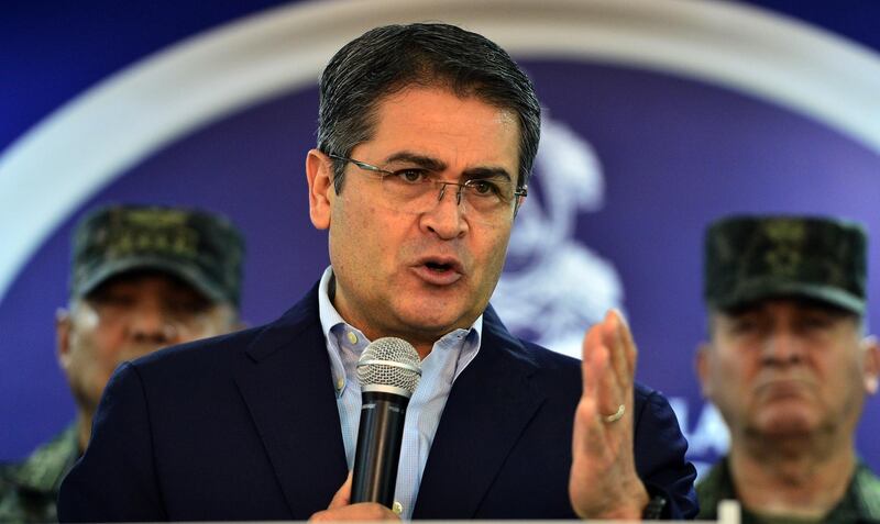 (FILES) In this file photo taken on June 20, 2019 Honduran President Juan Orlando Hernandez speaks at the presidential house in Tegucigalpa. Honduran President Juan Orlando Hernandez took millions of dollars in bribes from drug lords including jailed Mexican kingpin Joaquin "El Chapo" Guzman, a US prosecutor said on October 2, 2019, at the opening of his brother's trial. / AFP / ORLANDO SIERRA
