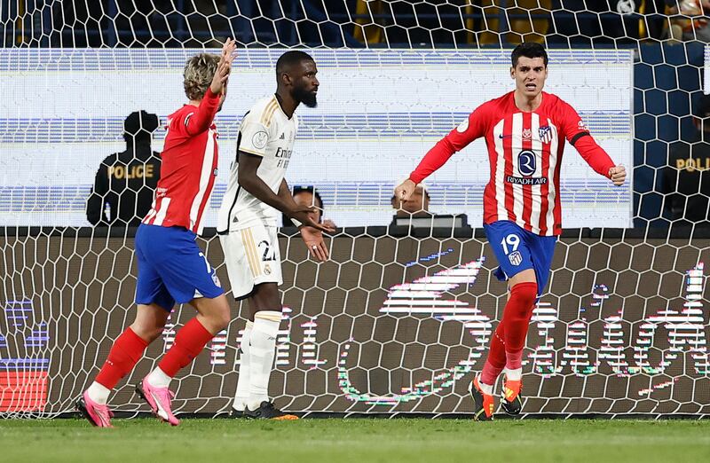 Alvaro Morata celebrates with Antoine Griezmann after Real Madrid's Antonio Rudiger scores an own goal for Atletico's third goal. Reuters