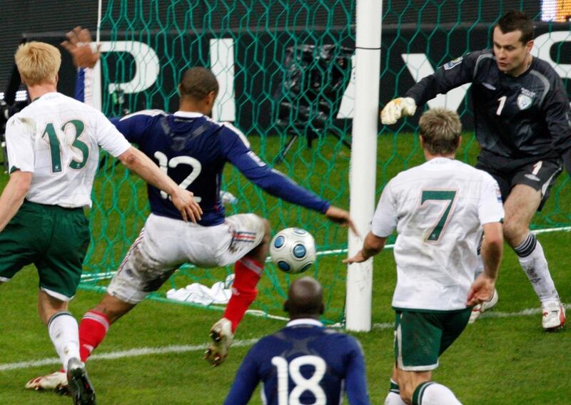 In this November 18, 2009 file photo, France's Thierry Henry, second left, passes the ball as Ireland's goalkeeper Shay Given, right, tries to stop it, just before William Gallas, unseen, scored the goal for France during their World Cup qualifying play-off second-leg match at the Stade de France. Michel Euler / AP Photo