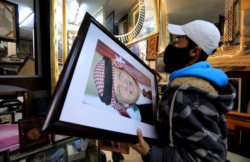 A frame maker in Amman displays a picture of king Abdullah II. EPA