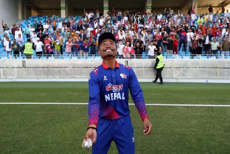 Nepal captain Rohit Paudel throws a signed ball into the crowd to celebrate their win after the game against the UAE in Cricket World Cup League 2. 